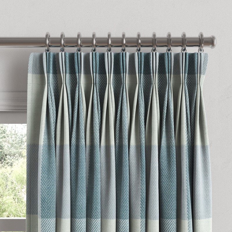 Elegant pinch pleat drapes in a formal living room