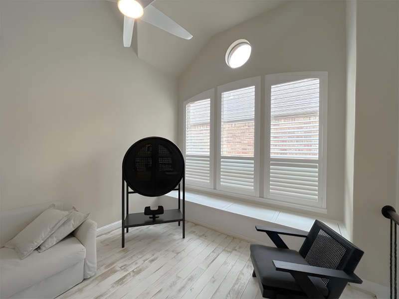 Full-height shutters framing a large window